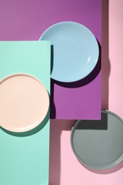 Abstract composition made of plates on color background, flat lay