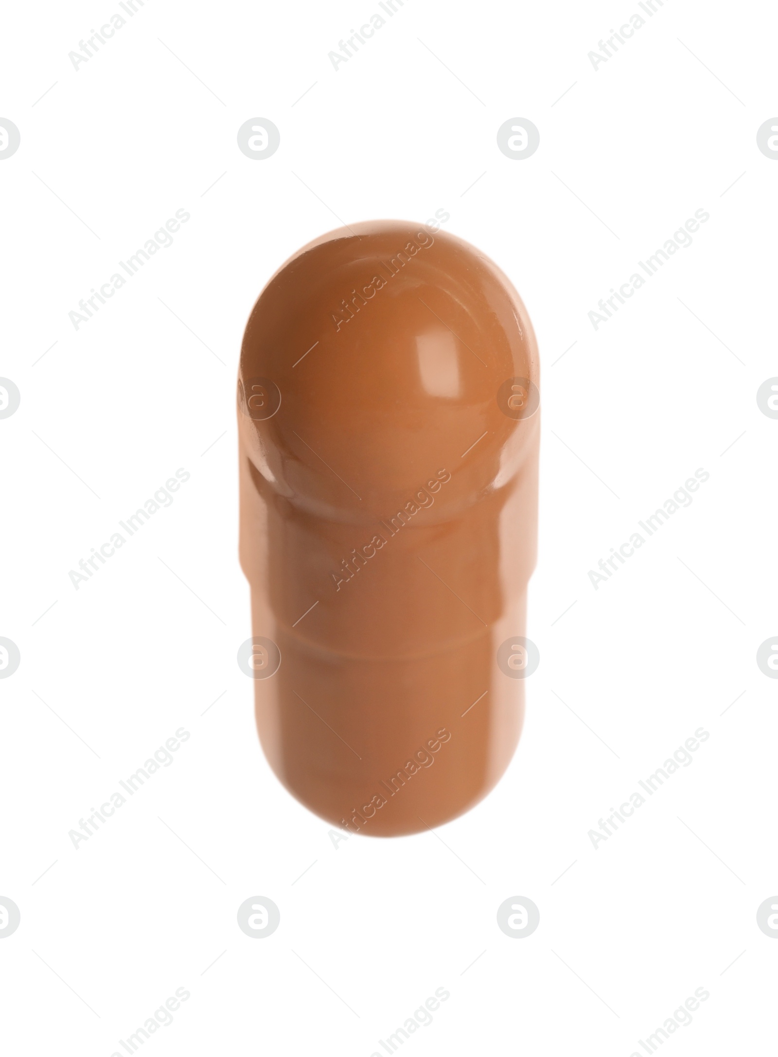 Photo of One brown pill on white background. Medicinal treatment