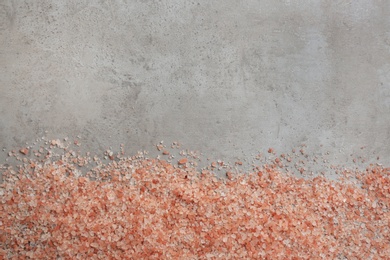 Photo of Pink himalayan salt on grey table, flat lay. Space for text