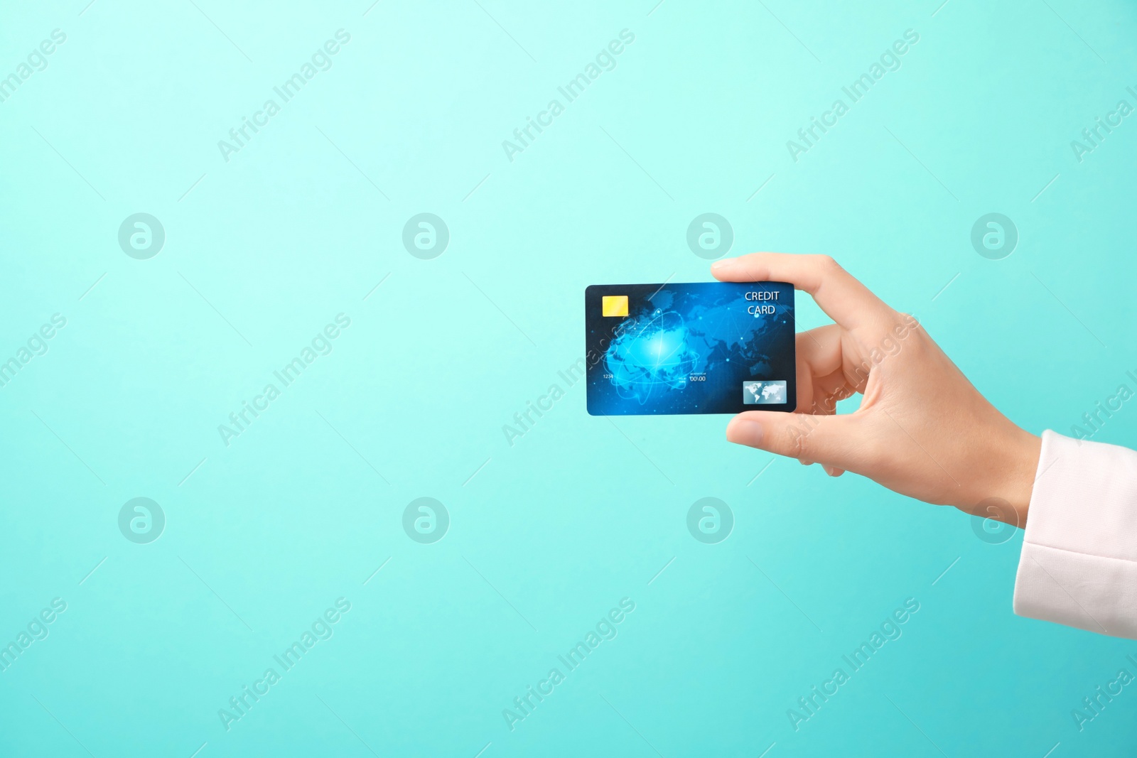 Photo of Woman holding credit card on color background