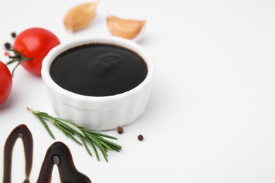Photo of Organic balsamic vinegar and cooking ingredients on white background. Space for text
