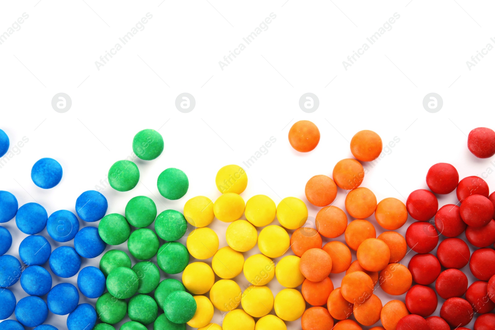 Photo of Tasty colorful candies on white background, top view