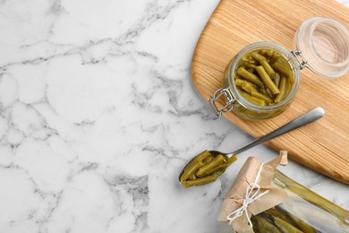 Photo of Canned green beans on white marble table, flat lay. Space for text