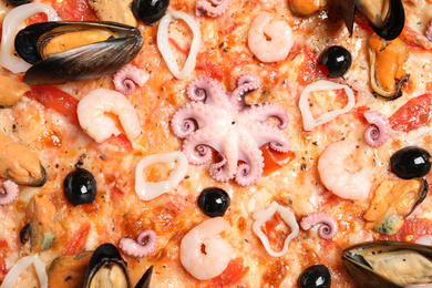 Photo of Delicious seafood pizza as background, closeup view