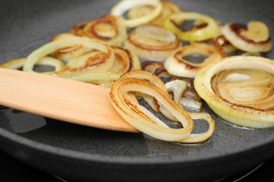 Cooking onion rings in frying pan, closeup