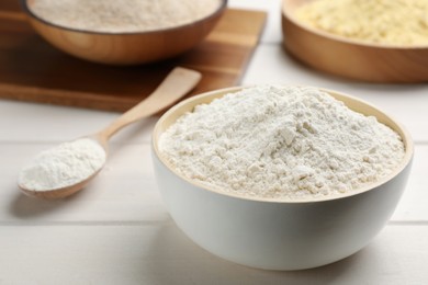 Photo of Bowl of flour on white wooden table