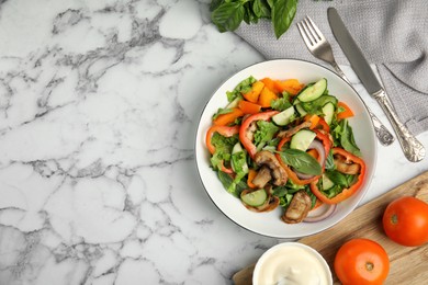 Photo of Delicious salad and bowl of mayonnaise on white marble table, flat lay. Space for text
