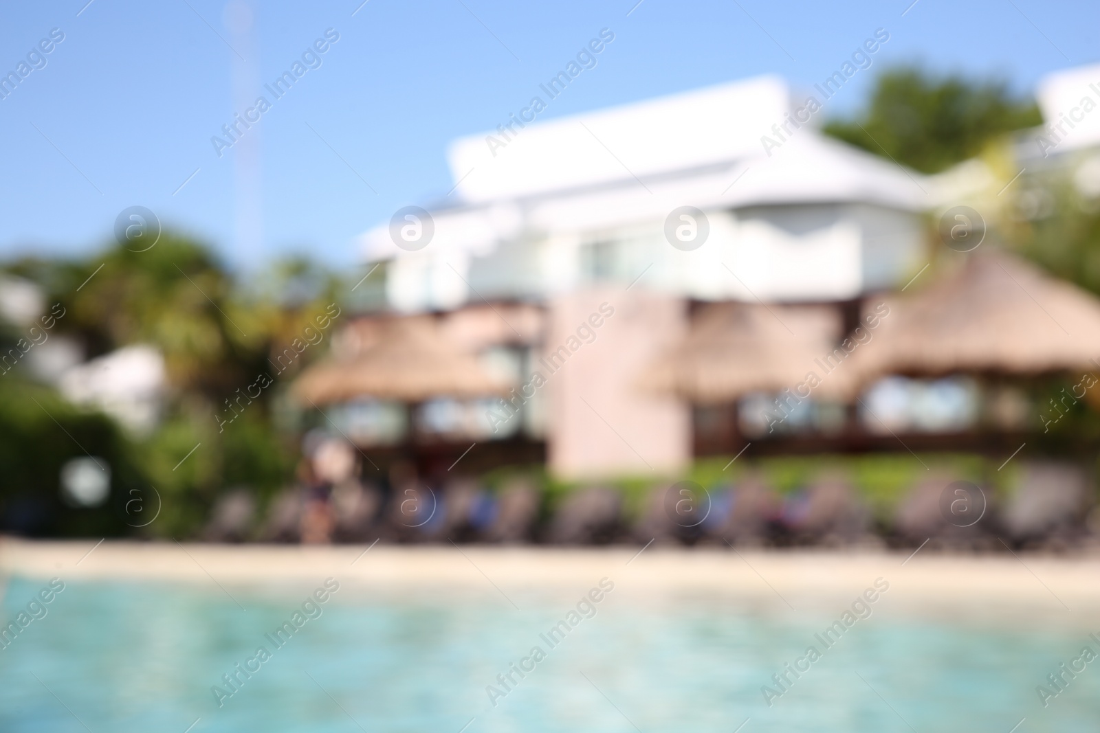 Photo of Blurred view of outdoor swimming pool at resort on sunny day