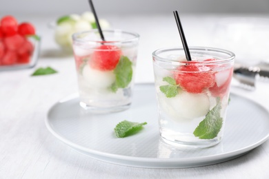 Photo of Glasses with tasty melon and watermelon ball drinks on plate