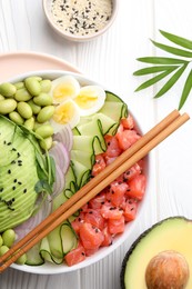 Photo of Delicious poke bowl with avocado, fish and edamame beans on white wooden table, flat lay