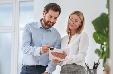 Happy businesspeople working with documents in office