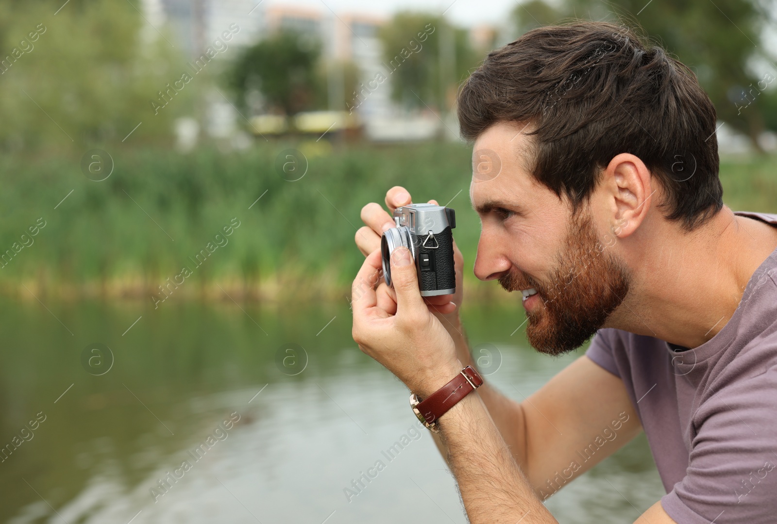 Photo of Man with camera taking photo outdoors, space for text. Interesting hobby