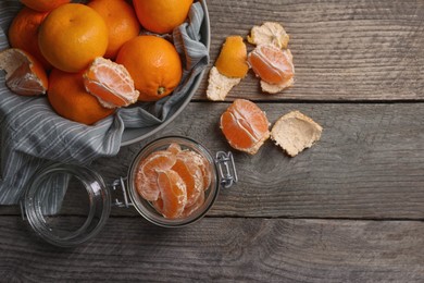 Photo of Many fresh ripe tangerines on wooden table, flat lay. Space for text