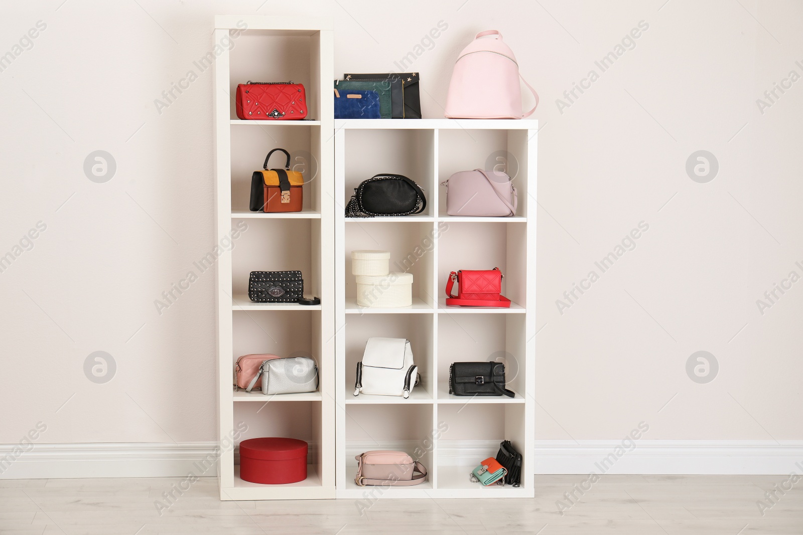 Photo of Wardrobe shelves with different stylish bags indoors. Idea for interior design