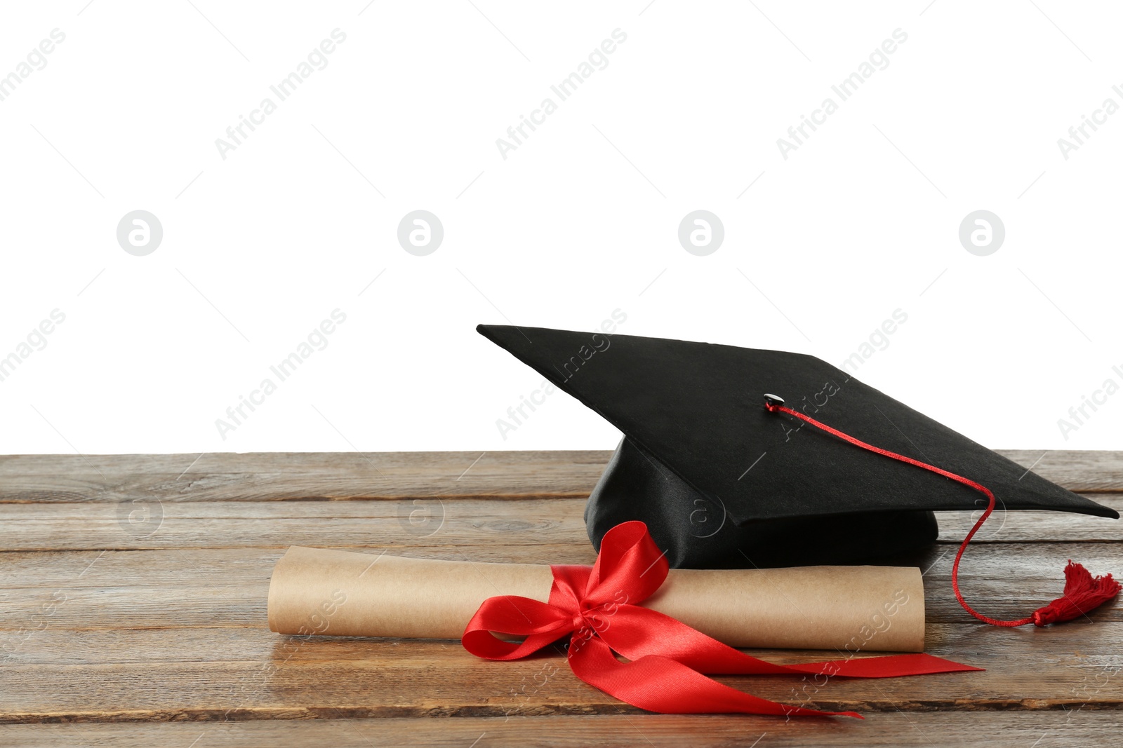 Photo of Graduation hat and diploma on wooden table against  white background, space for text