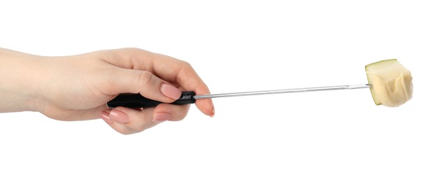 Tasty fondue. Woman holding fork with piece of pear and melted cheese on white background, closeup