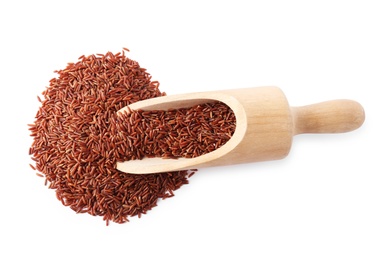 Photo of Scoop and uncooked brown rice on white background, top view