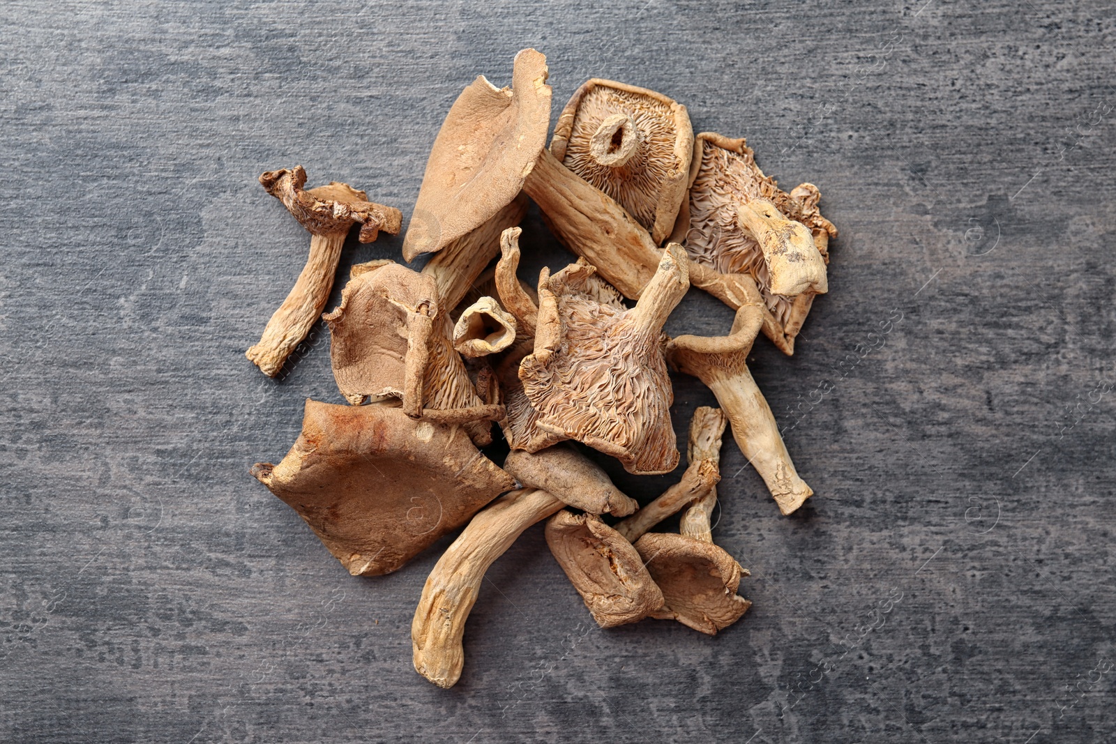 Photo of Dried mushrooms on color background, top view