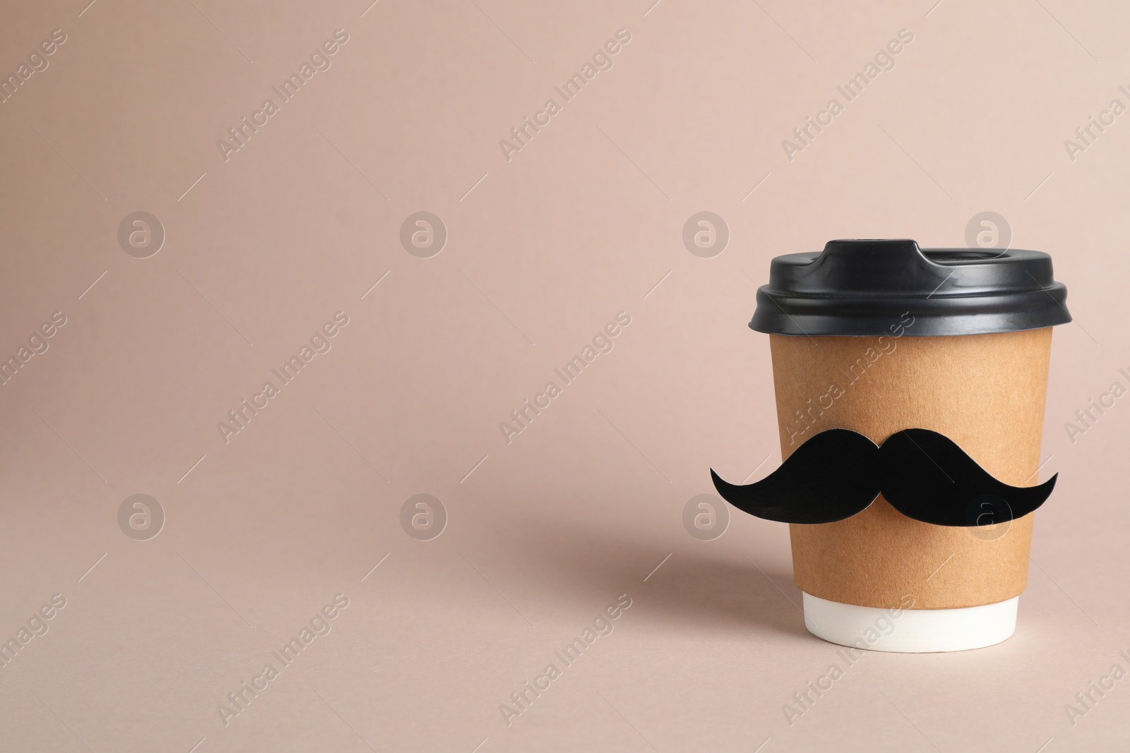 Photo of Paper cup of drink with fake mustache on grey background. Space for text