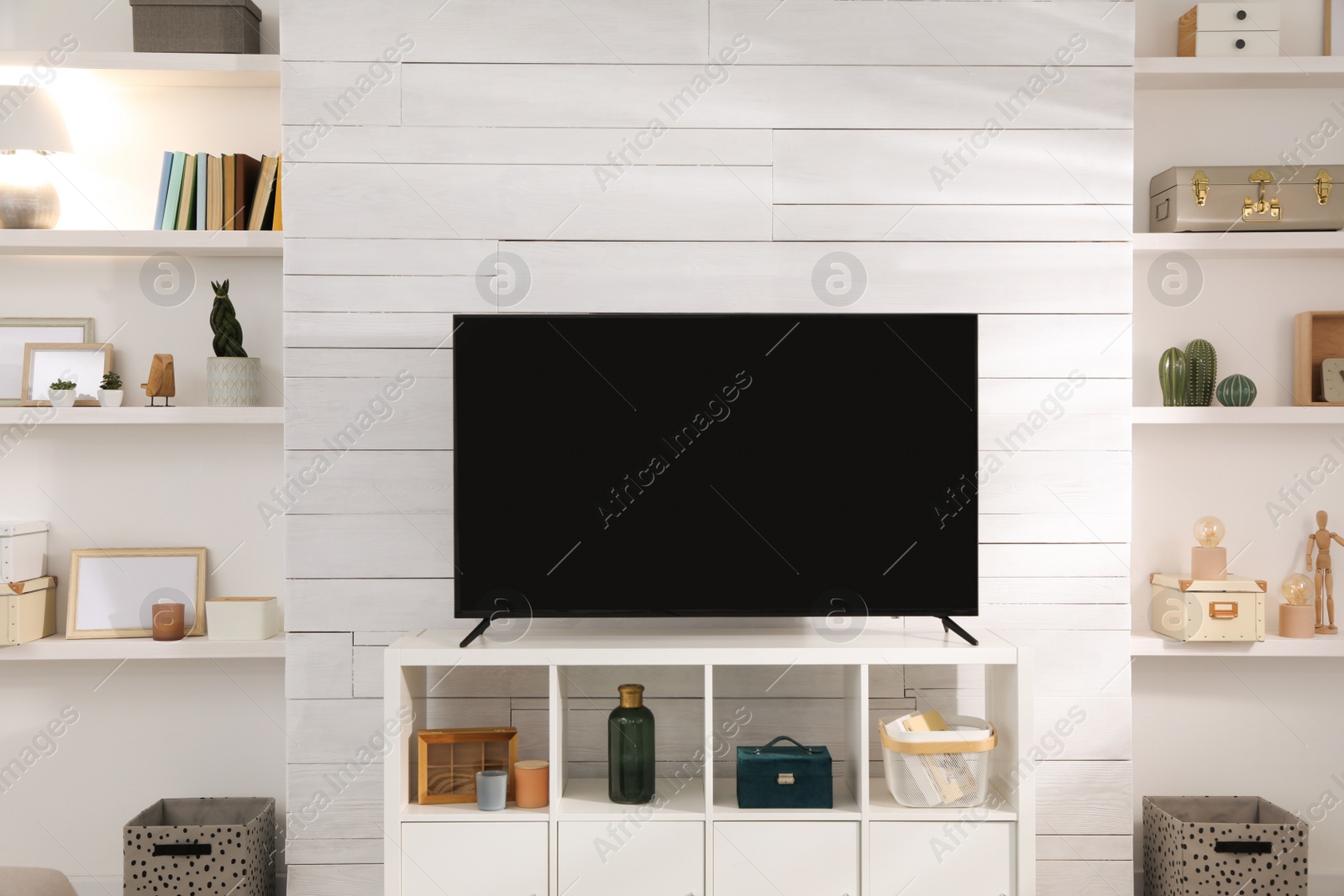 Photo of Cozy room interior with stylish decor and modern TV set