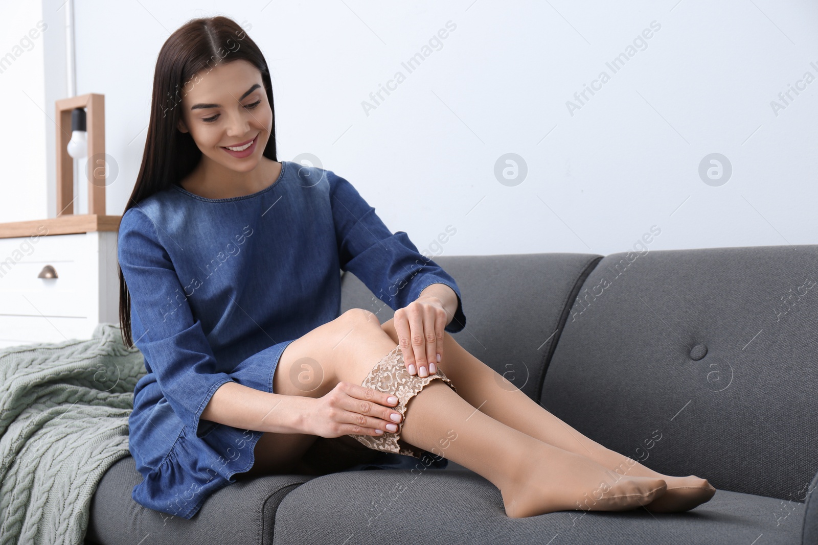 Photo of Woman wearing compression tights in living room. Space for text