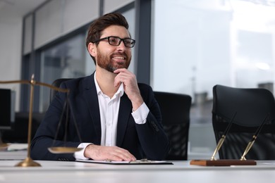 Photo of Smiling lawyer at table in office, space for text