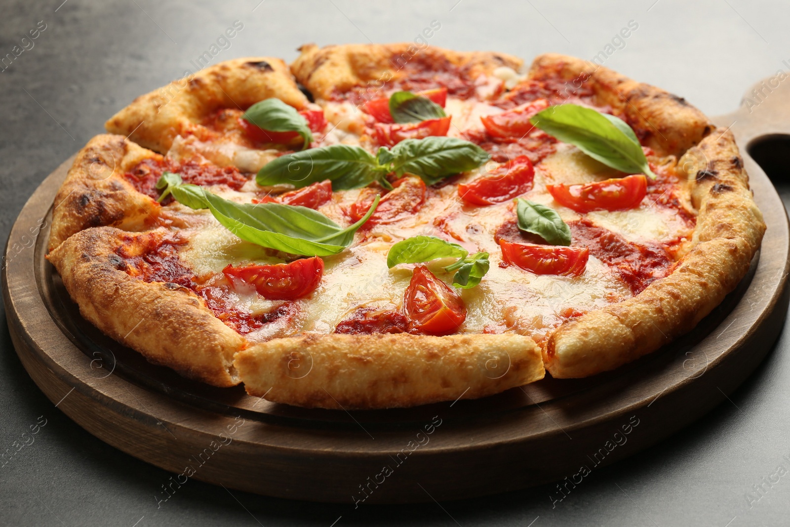Photo of Delicious Margherita pizza on grey table, closeup