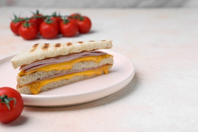 Photo of Delicious grilled sandwich with ham, cheese and tomatoes on white table, space for text