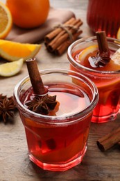 Photo of Aromatic punch drink and ingredients on wooden table