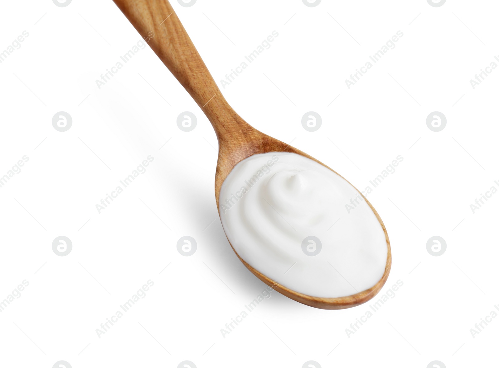 Photo of One wooden spoon with sour cream isolated on white