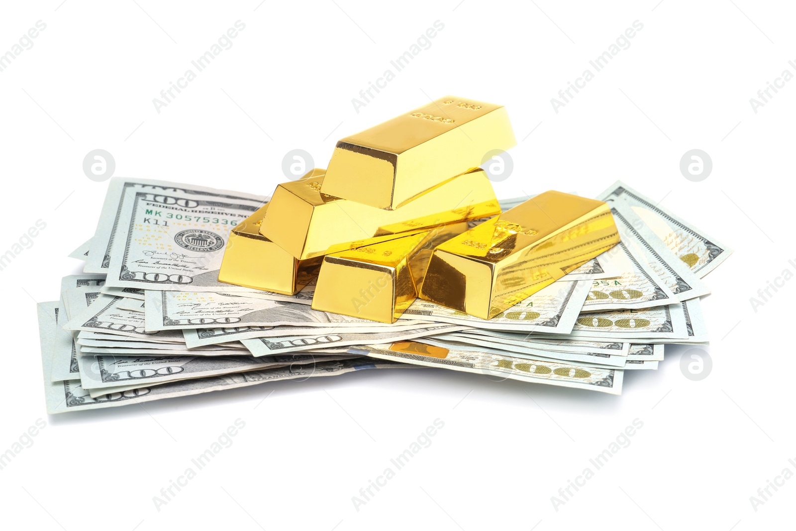 Photo of Shiny gold bars and money on white background