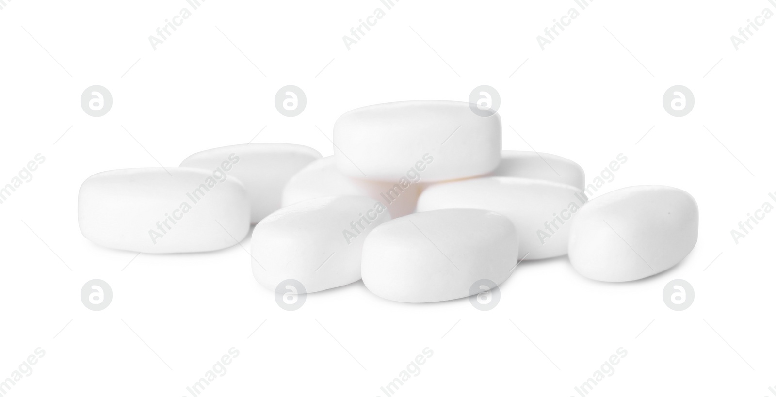 Photo of Tasty mint dragee candies on white background