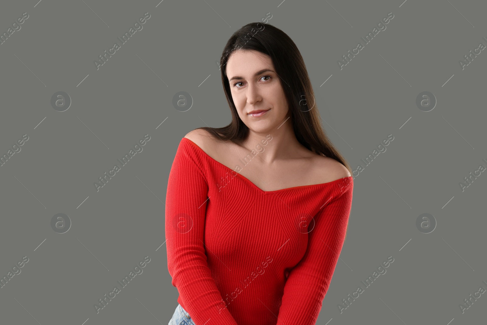 Photo of Portrait of beautiful young woman on grey background