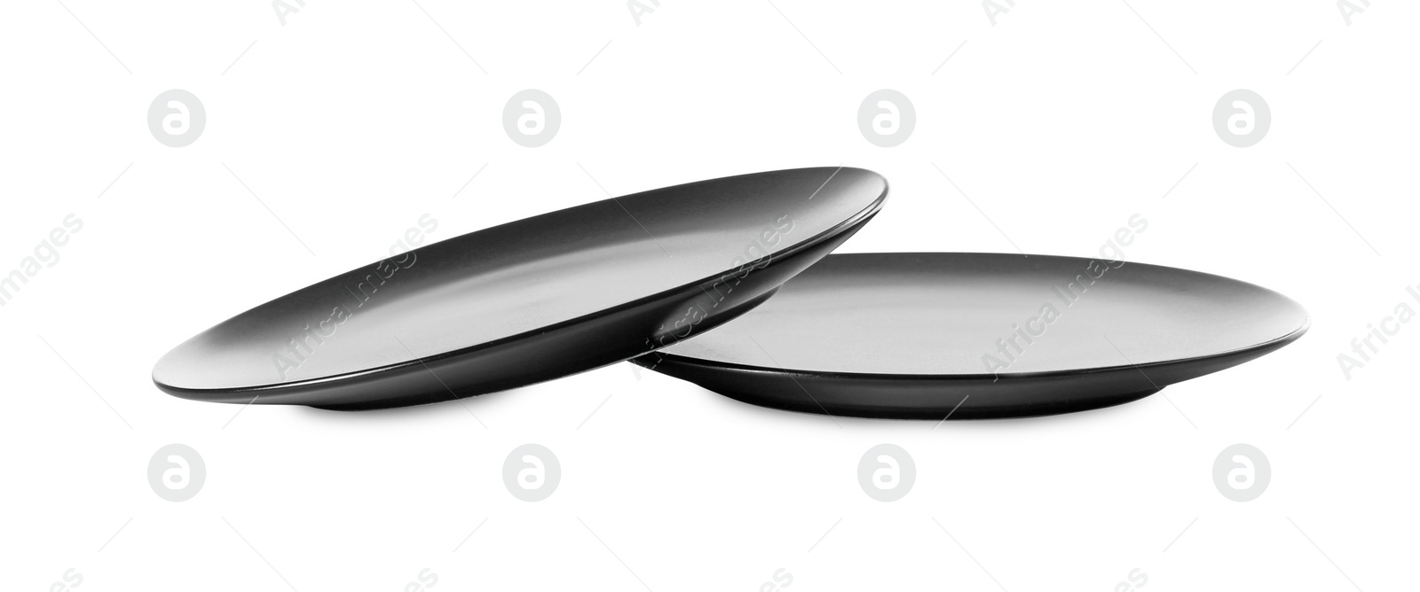 Photo of Two clean ceramic plates isolated on white