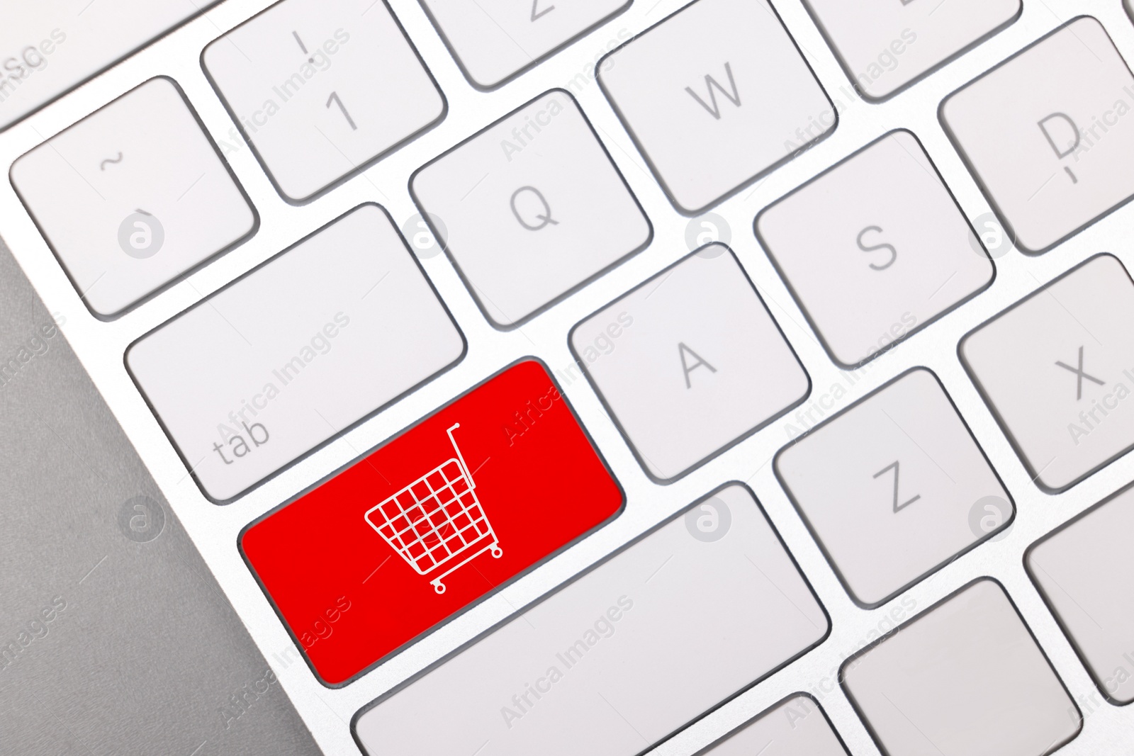 Image of Internet store. Red button with shopping cart on computer keyboard, top view