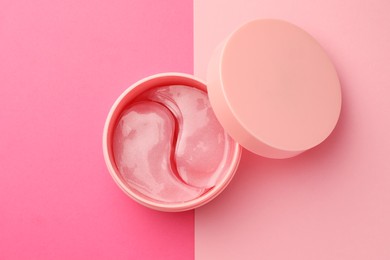 Photo of Jar of under eye patches on pink background, top view. Cosmetic product