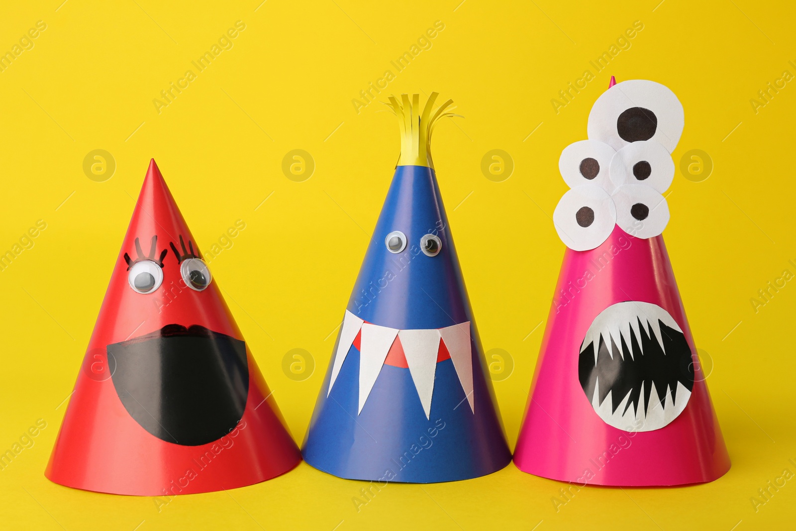 Photo of Funny monsters on yellow background. Halloween decoration