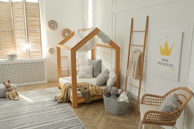 Stylish child room interior with house bed