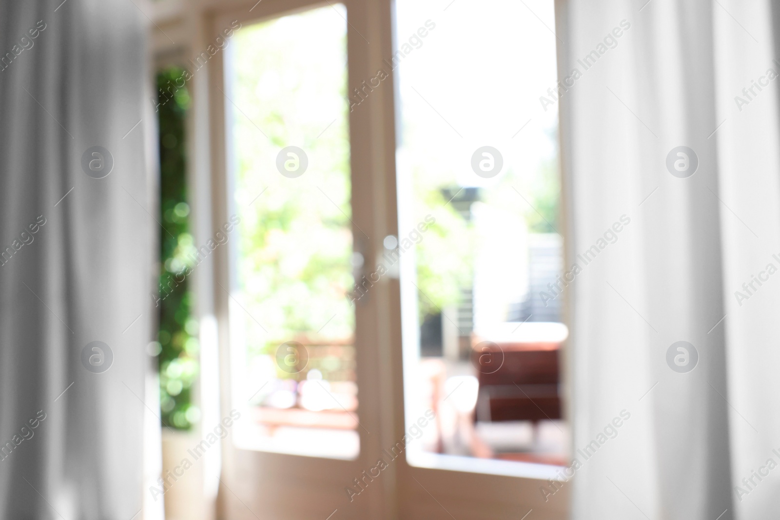 Photo of Blurred view of glass door at home