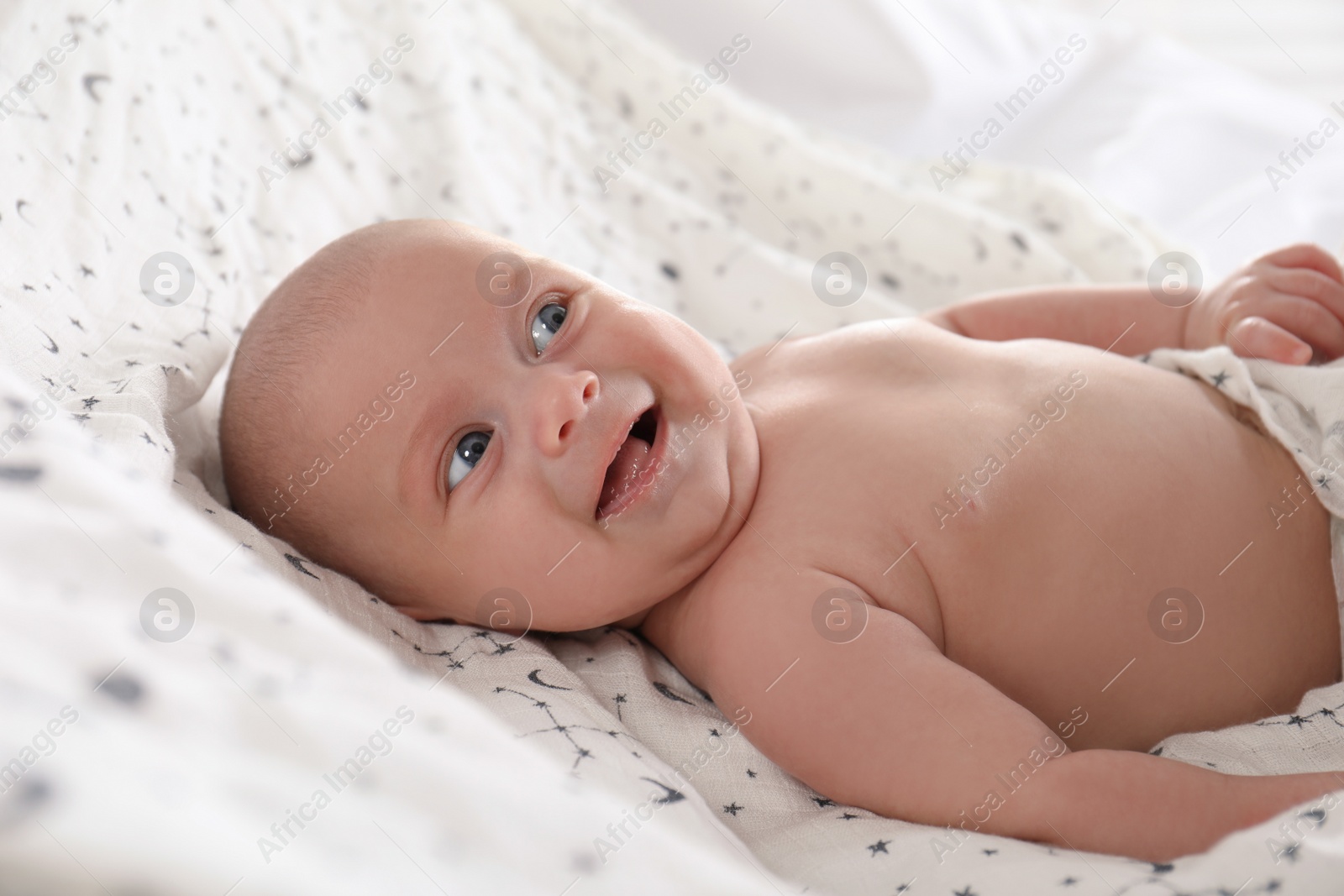 Photo of Cute little baby lying on white blanket