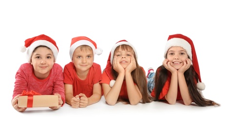 Cute little children in Santa hats on white background. Christmas celebration