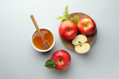 Photo of Sweet honey and fresh apples on white table, flat lay