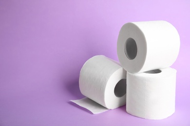Photo of Toilet paper rolls on color background. Space for text