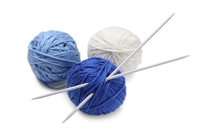 Photo of Soft woolen yarns with knitting needles on white background