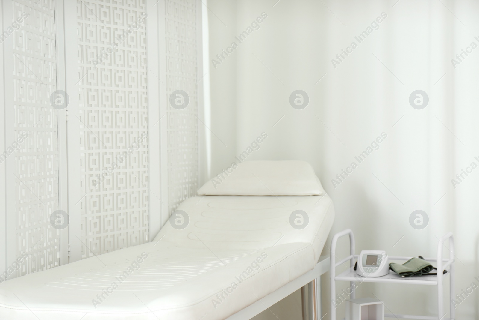 Photo of Empty examination couch in modern medical office