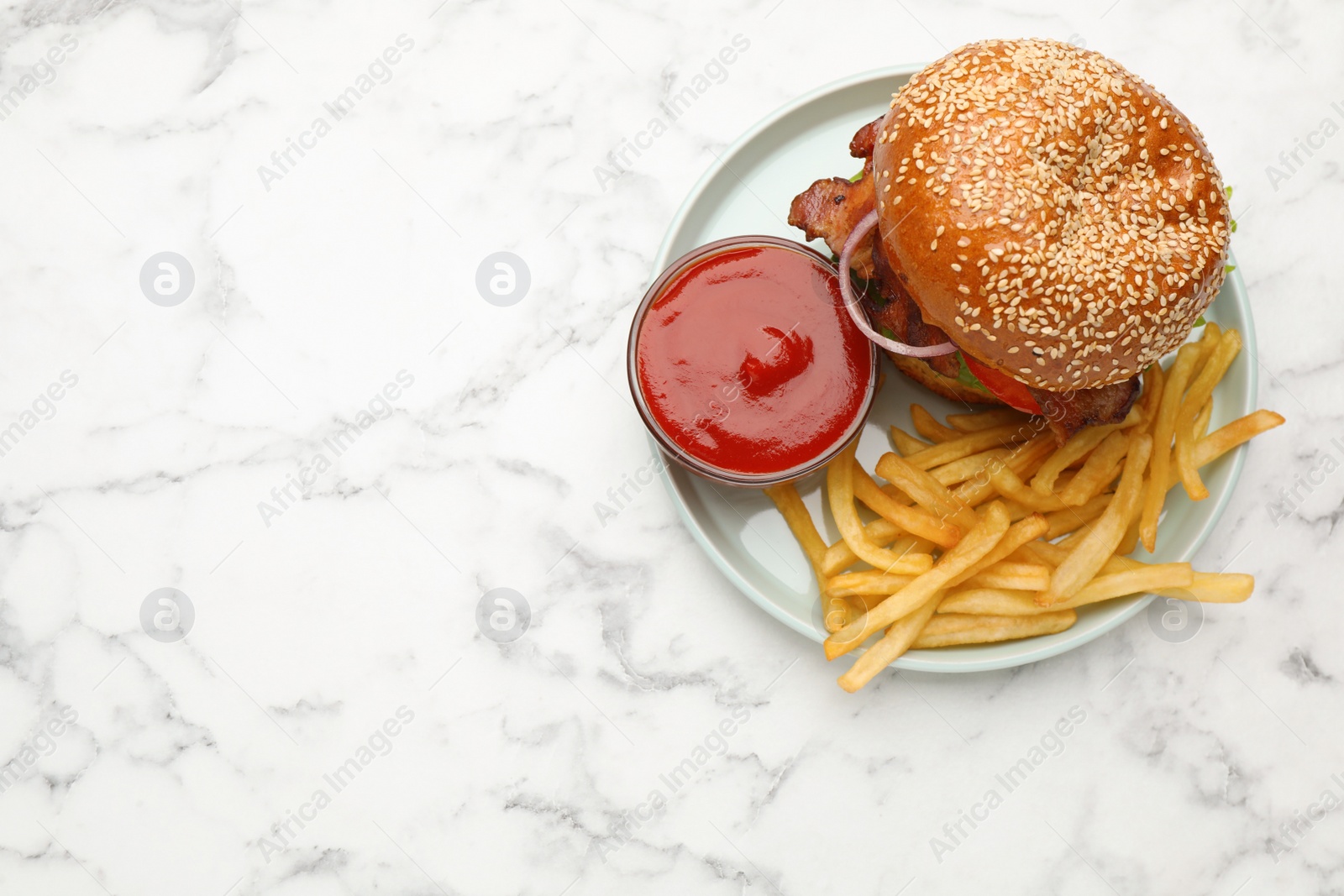 Photo of Tasty burger, French fries and sauce on white marble table, top view with space for text. Fast food