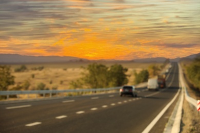 Photo of Blurred view of asphalt highway with traffic. Road trip