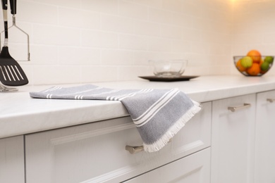 Photo of Clean kitchen towel on counter at home, closeup