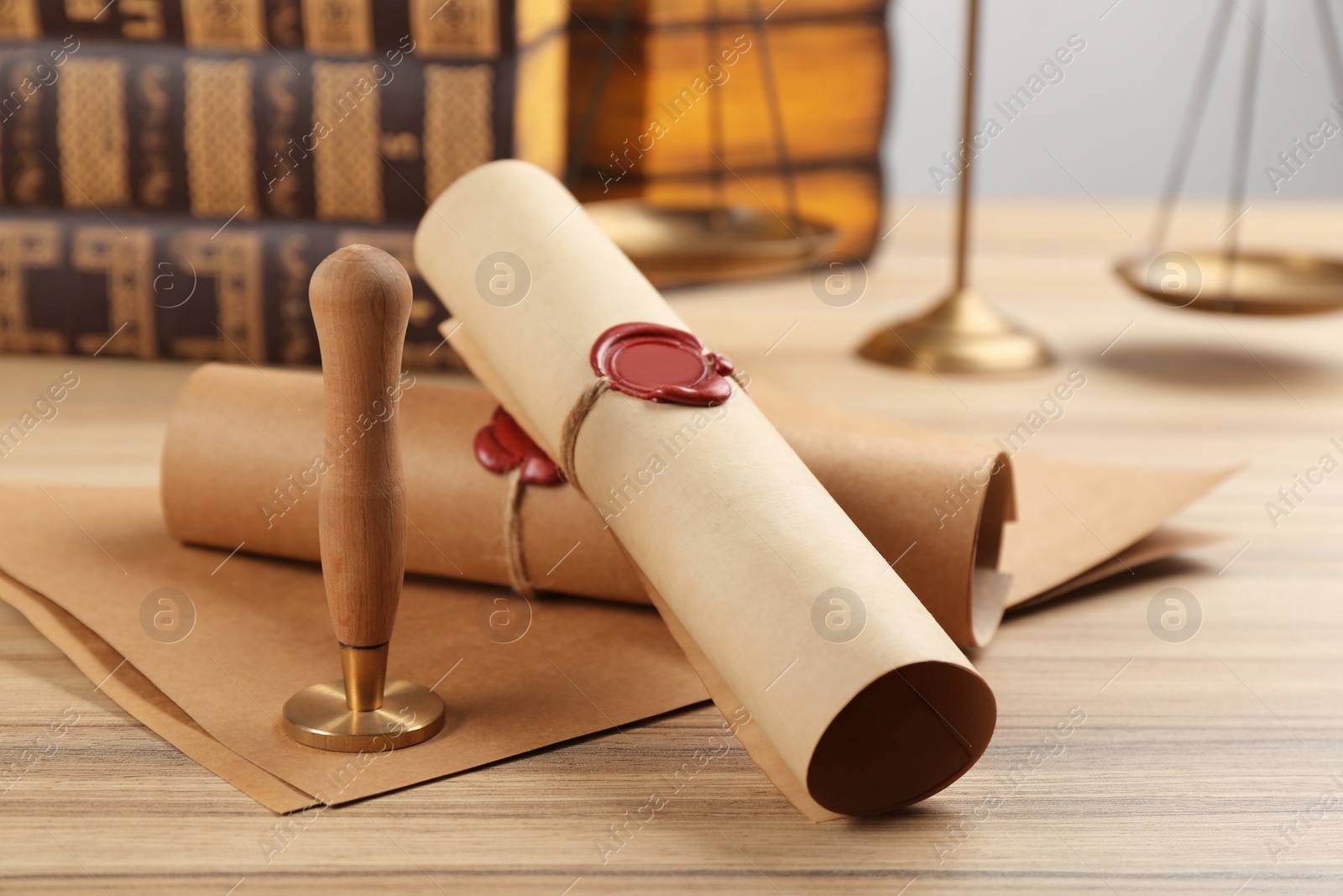 Photo of Notary's public pen and documents with wax stamp on wooden table, closeup