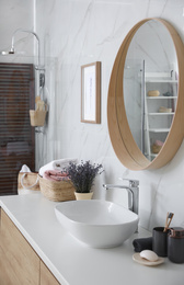 Photo of Mirror and counter with vessel sink in bathroom interior. Idea for design